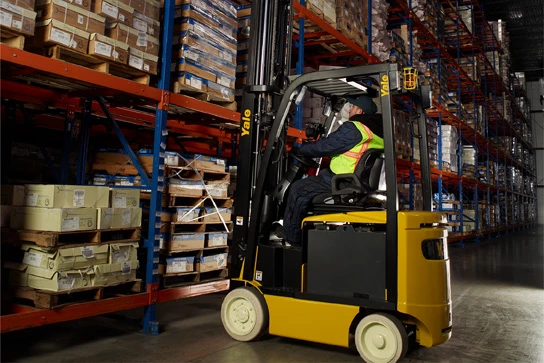 Yale forklift retrieving pallet from warehouse racking